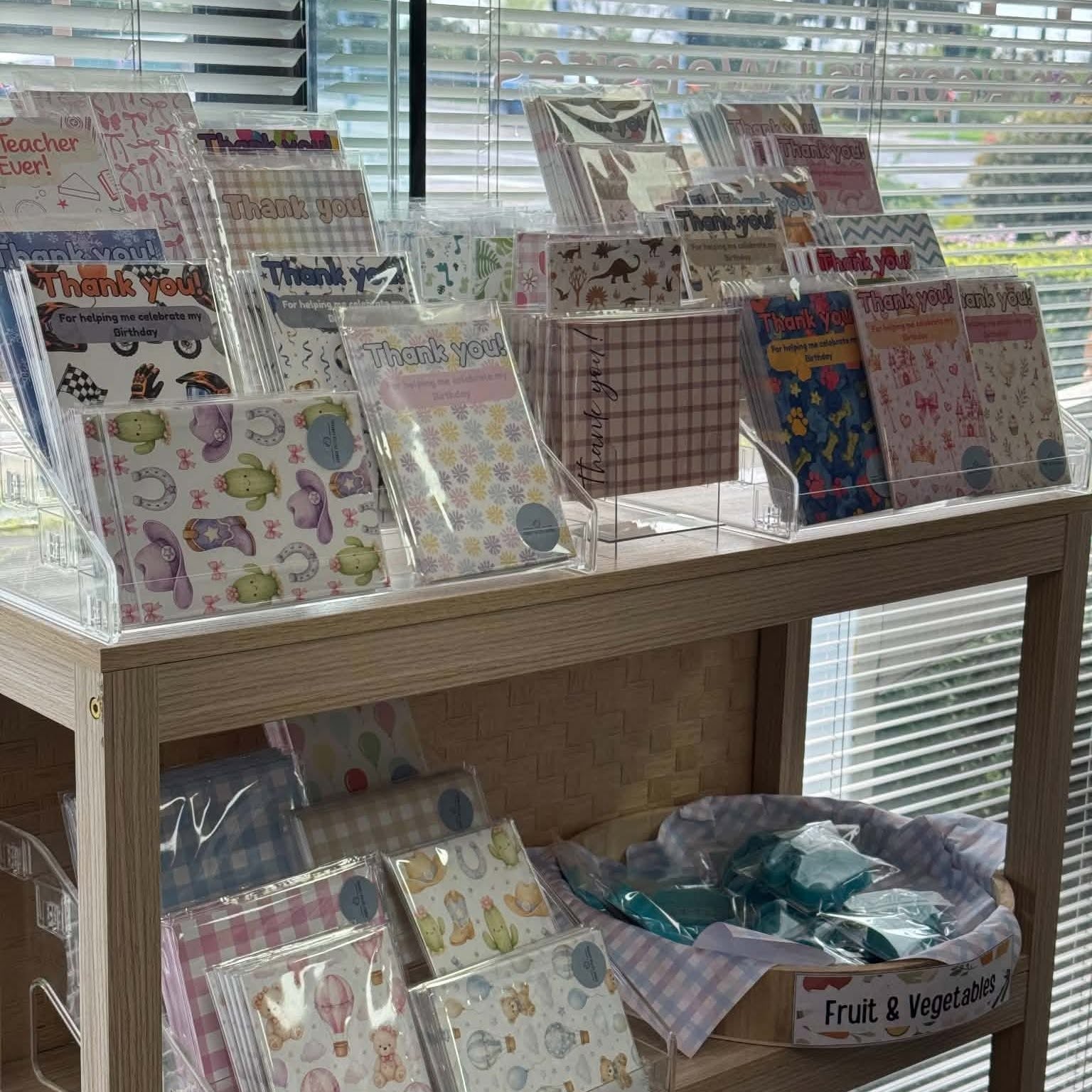 Stamps and baking products arranged on shelves by the shop window